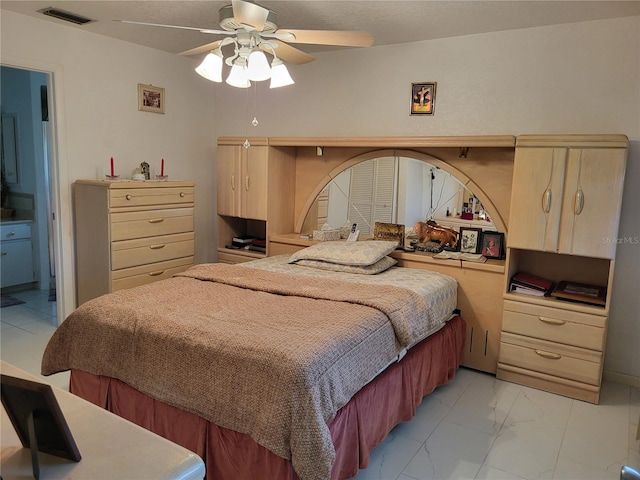 bedroom featuring ceiling fan and ensuite bathroom