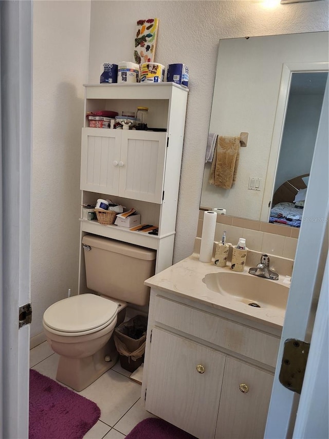 bathroom featuring decorative backsplash, toilet, vanity, and tile patterned flooring