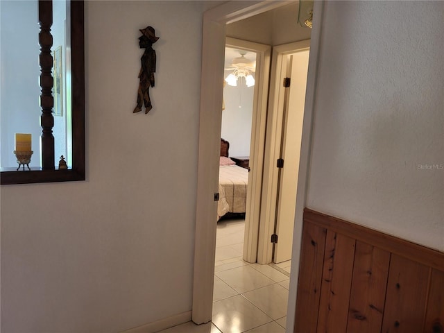 hall with light tile patterned floors