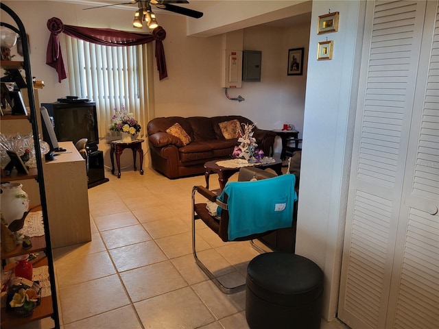 tiled living room featuring ceiling fan and electric panel