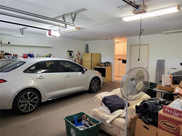 garage with washing machine and dryer, fridge, and a garage door opener