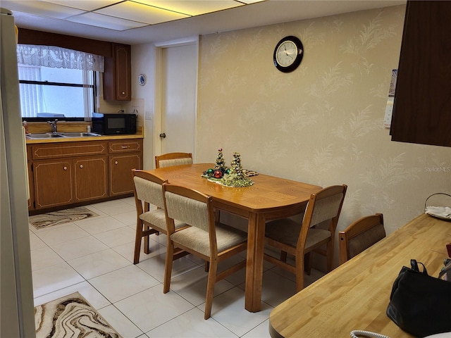 tiled dining space featuring sink