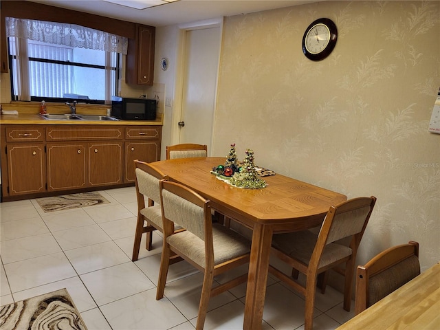 tiled dining space featuring sink