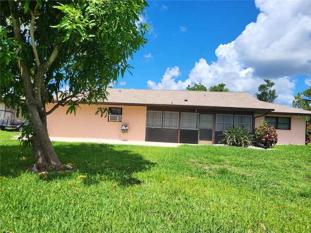 rear view of house featuring a lawn