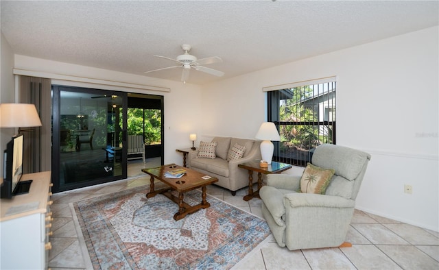 tiled living room with ceiling fan and a textured ceiling