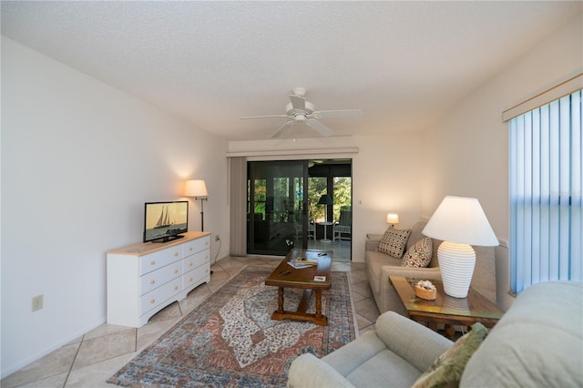 tiled living room featuring ceiling fan and a textured ceiling