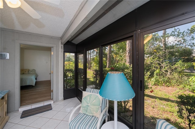 sunroom / solarium featuring ceiling fan