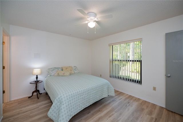 bedroom with ceiling fan and light wood-type flooring