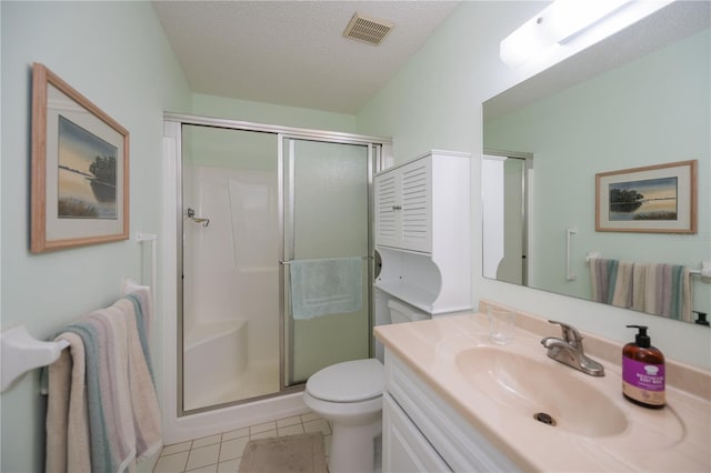 bathroom featuring tile patterned floors, an enclosed shower, vanity, a textured ceiling, and toilet