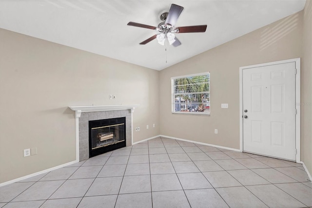 unfurnished living room featuring ceiling fan, vaulted ceiling, a tile fireplace, and light tile patterned flooring