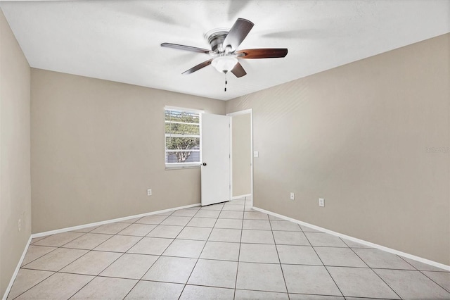 tiled spare room featuring ceiling fan