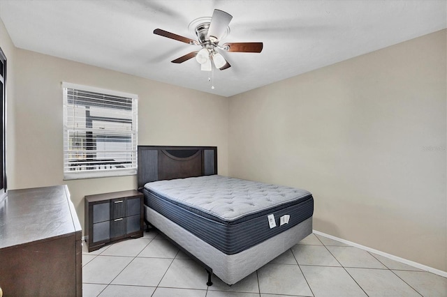 tiled bedroom featuring ceiling fan