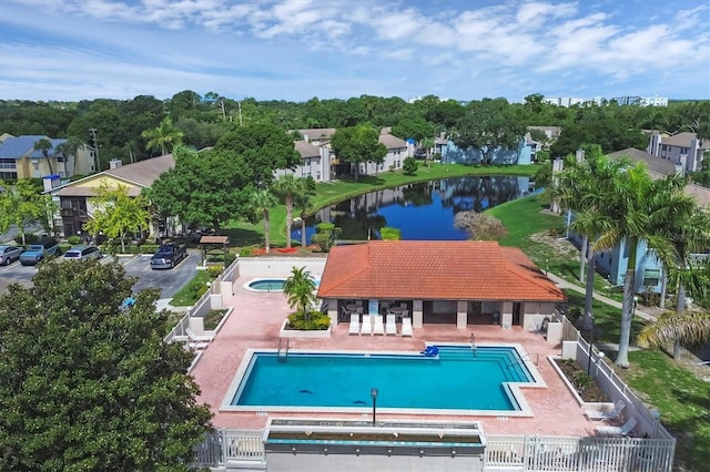 view of swimming pool with a water view and a patio area