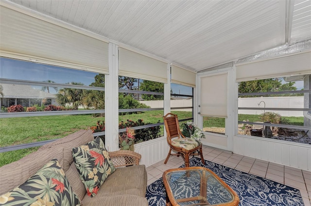 sunroom featuring lofted ceiling