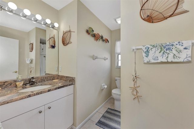 bathroom featuring vanity, tile patterned flooring, and toilet