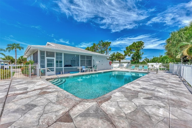 view of pool with a patio and a sunroom