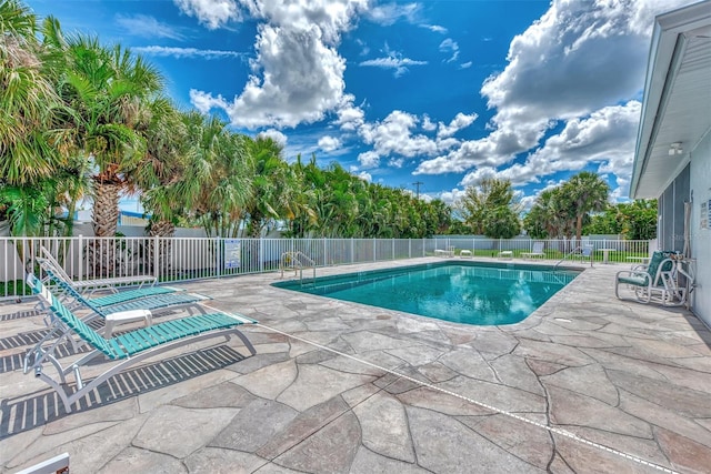 view of swimming pool featuring a patio area and a jacuzzi