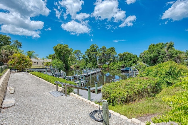 surrounding community featuring a dock and a water view