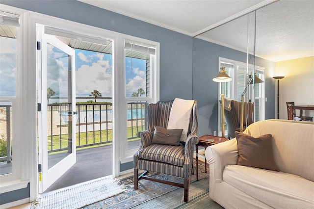 sitting room with crown molding, french doors, and wood-type flooring