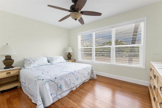 bedroom with hardwood / wood-style floors and ceiling fan