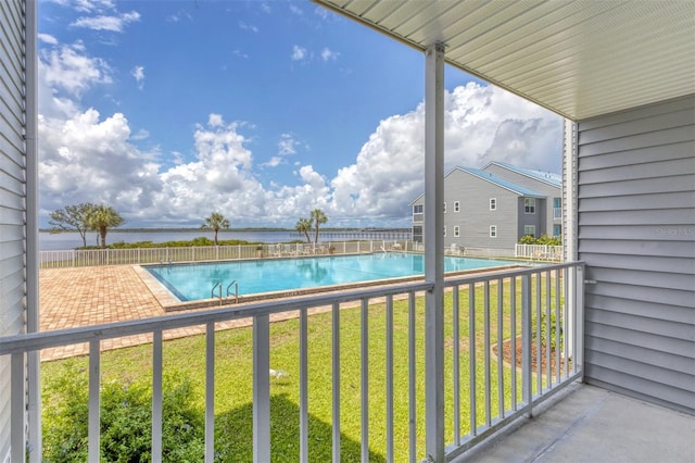 balcony featuring a patio area and a water view