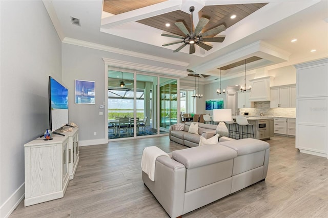 living room with ceiling fan with notable chandelier, light wood-type flooring, wood ceiling, and crown molding