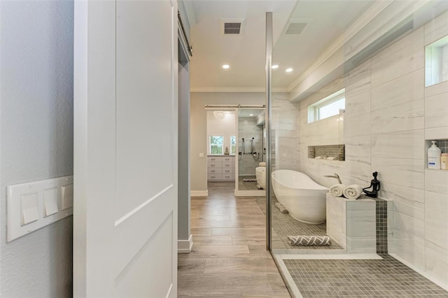 bathroom with hardwood / wood-style flooring, independent shower and bath, and ornamental molding