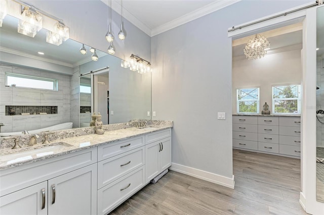 bathroom with tiled shower, vanity, hardwood / wood-style flooring, and plenty of natural light