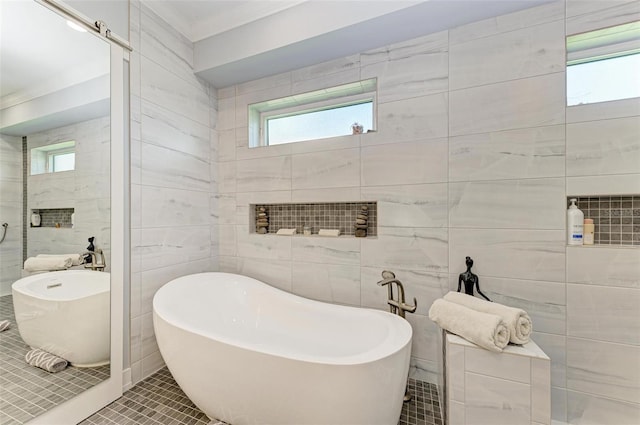 bathroom featuring tile patterned flooring, tile walls, and a wealth of natural light