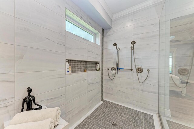 bathroom featuring tile patterned flooring, a tile shower, and ornamental molding