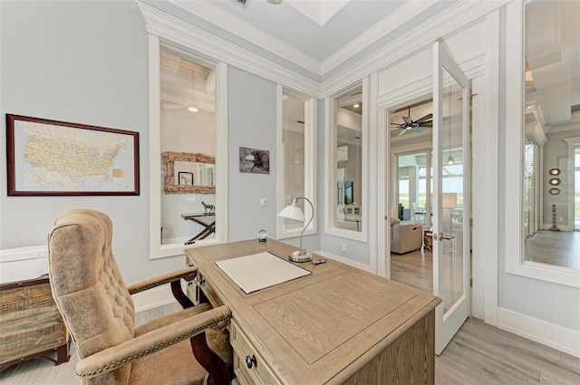 office space with light hardwood / wood-style floors, ornamental molding, and french doors