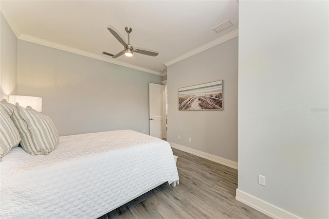 bedroom featuring hardwood / wood-style flooring, ceiling fan, and ornamental molding