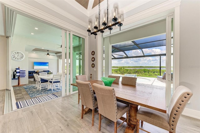 dining room featuring ceiling fan with notable chandelier and ornamental molding