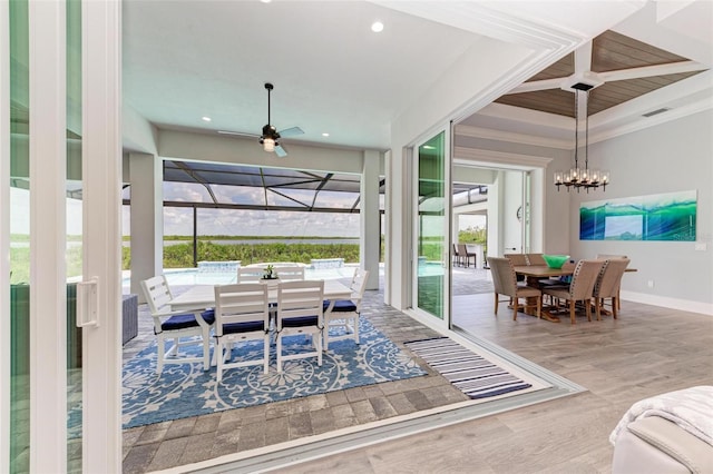 interior space with hardwood / wood-style flooring, ceiling fan with notable chandelier, and ornamental molding