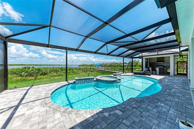 view of swimming pool featuring a lanai, a patio area, exterior kitchen, and an in ground hot tub