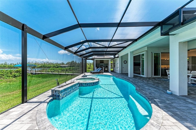 view of swimming pool featuring an in ground hot tub, a patio, a lanai, and a lawn