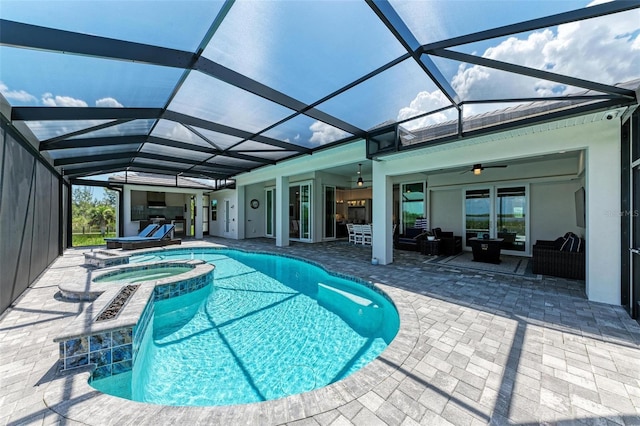 view of swimming pool featuring outdoor lounge area, ceiling fan, a lanai, an in ground hot tub, and a patio area