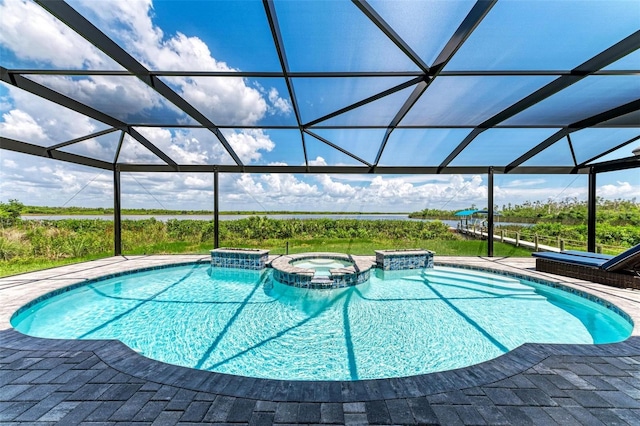 view of pool featuring glass enclosure and an in ground hot tub