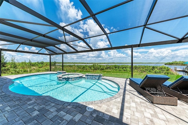 view of swimming pool with glass enclosure, an in ground hot tub, and a patio