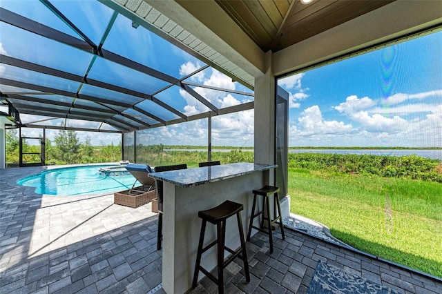 view of swimming pool with a patio and an outdoor bar