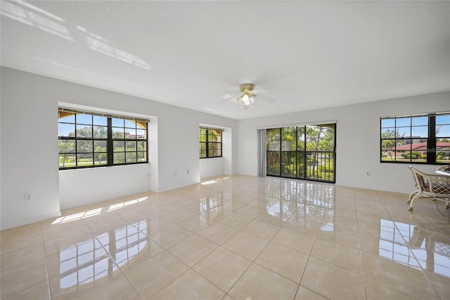 unfurnished room with ceiling fan and light tile patterned flooring