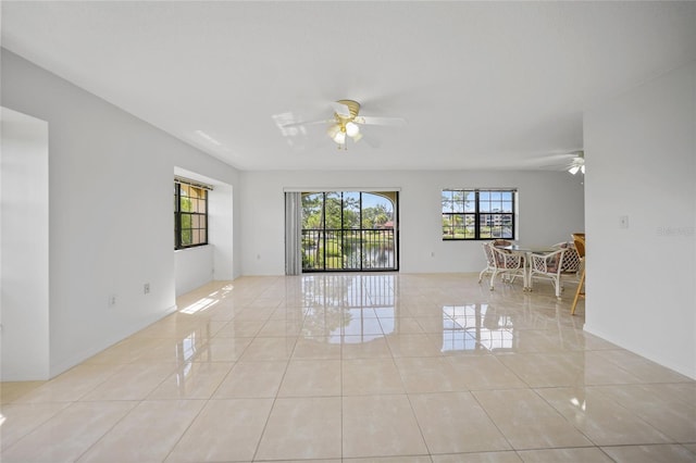 tiled empty room with ceiling fan