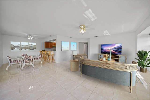 tiled living room with ceiling fan