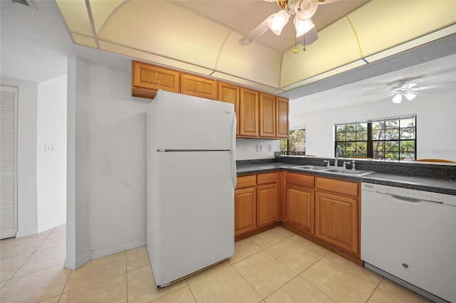 kitchen featuring white appliances, sink, ceiling fan, a textured ceiling, and light tile patterned flooring