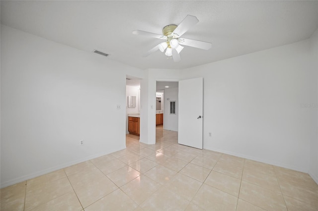 tiled empty room with ceiling fan