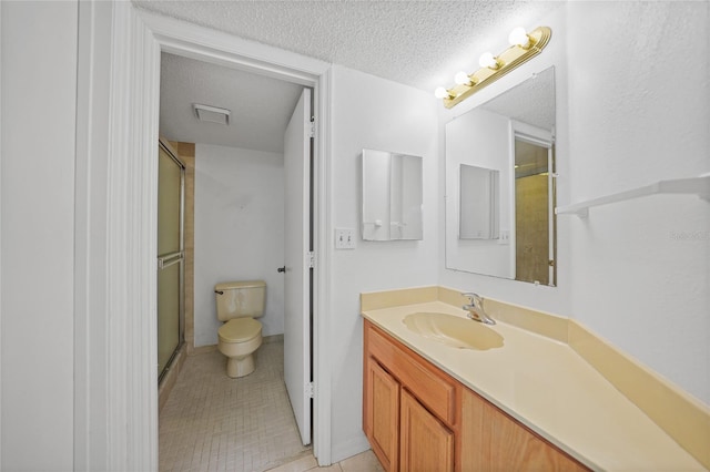 bathroom featuring a textured ceiling, vanity, toilet, and an enclosed shower