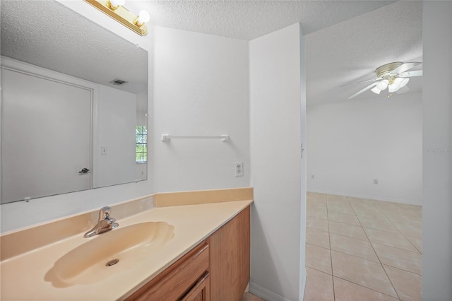 bathroom with vanity, a textured ceiling, tile patterned floors, and ceiling fan