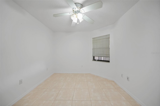 tiled empty room featuring a textured ceiling and ceiling fan