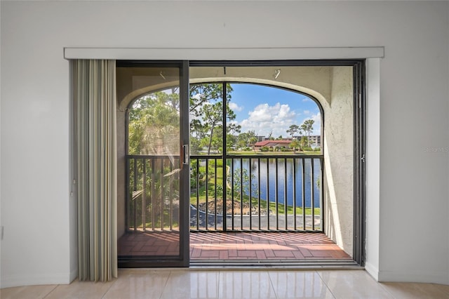 entryway featuring light tile patterned flooring and a water view