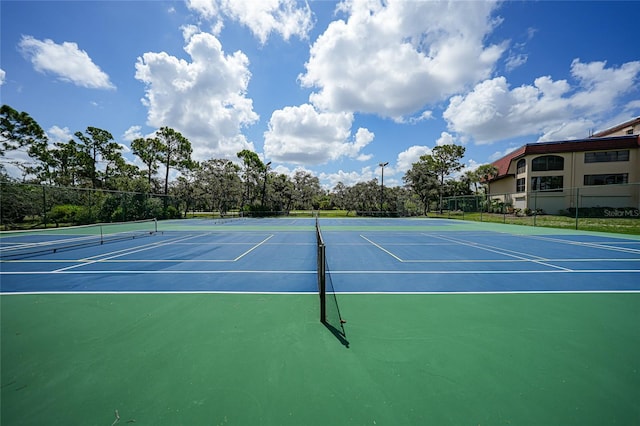 view of tennis court featuring basketball court